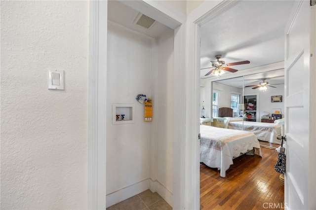 bedroom with hardwood / wood-style floors and ceiling fan