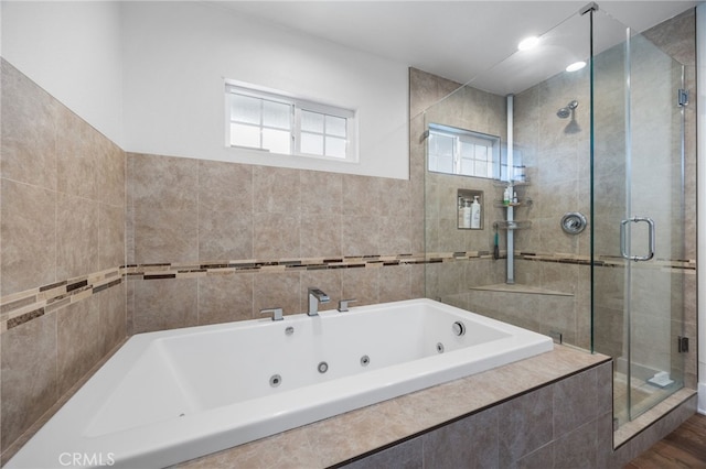 bathroom featuring shower with separate bathtub