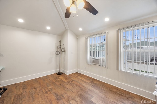 spare room with ceiling fan, hardwood / wood-style floors, vaulted ceiling, and a mountain view