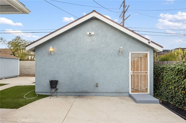 exterior space featuring a patio area and an outdoor structure