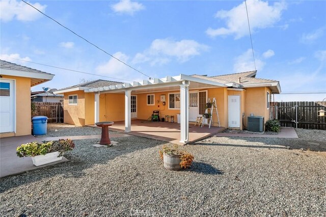 rear view of house featuring a patio and central AC