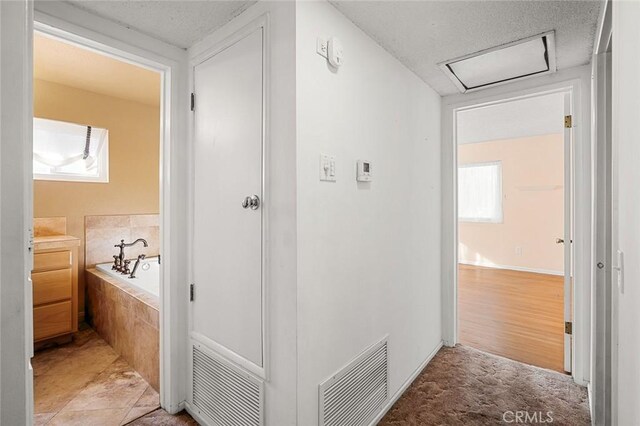 hall featuring light tile patterned floors