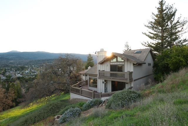 rear view of house featuring a mountain view and a balcony