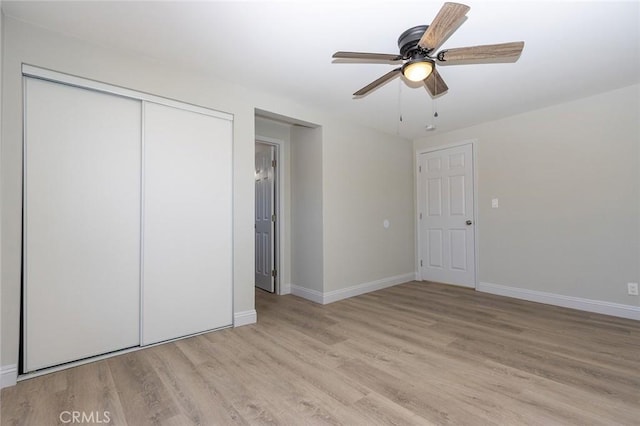 unfurnished bedroom with a closet, ceiling fan, and light wood-type flooring