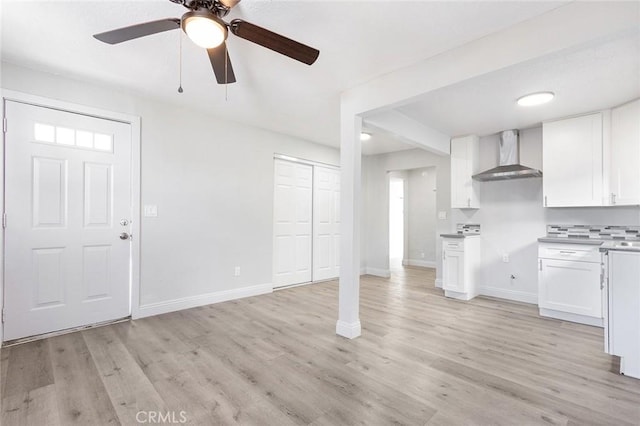 unfurnished living room featuring ceiling fan and light hardwood / wood-style flooring