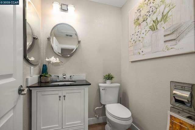 bathroom featuring vanity and toilet