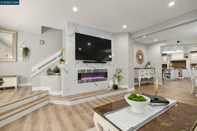 living room featuring wood-type flooring and a fireplace