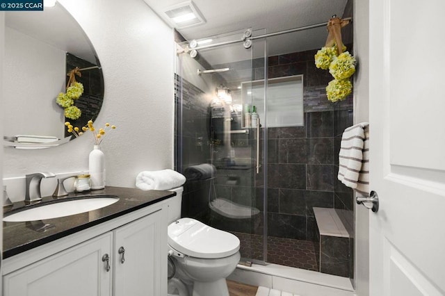 bathroom with vanity, toilet, and an enclosed shower