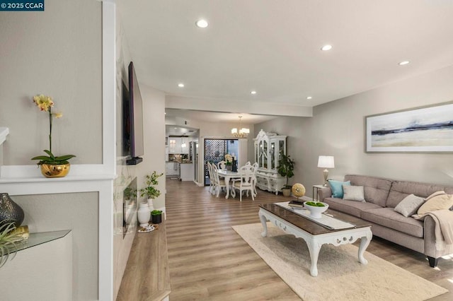 living room with an inviting chandelier and hardwood / wood-style floors