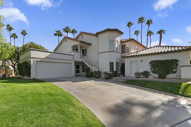 mediterranean / spanish home with a front lawn and a garage