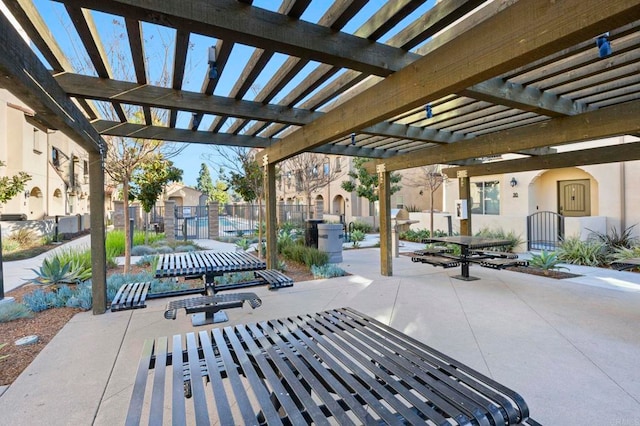 view of patio with a residential view, fence, and a pergola