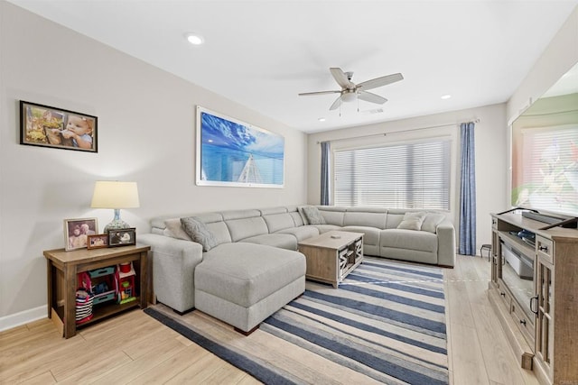 living area with baseboards, recessed lighting, a ceiling fan, and light wood-style floors