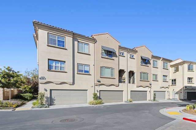 view of front of home featuring an attached garage and stucco siding