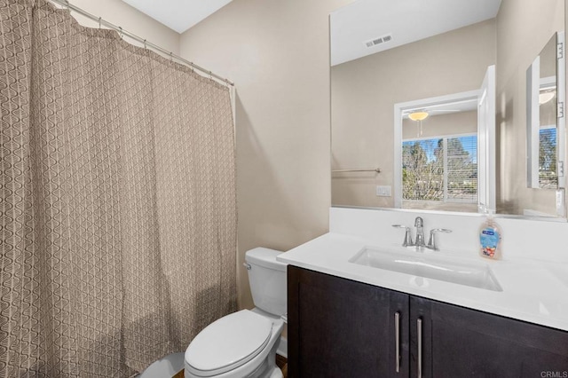 full bath with toilet, visible vents, and vanity