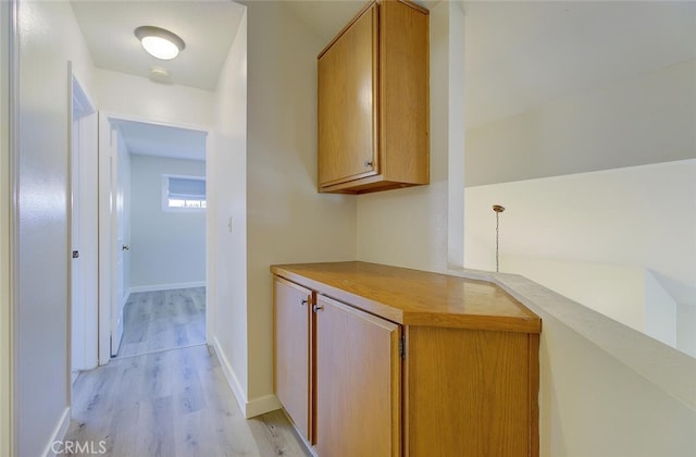 corridor with light hardwood / wood-style floors