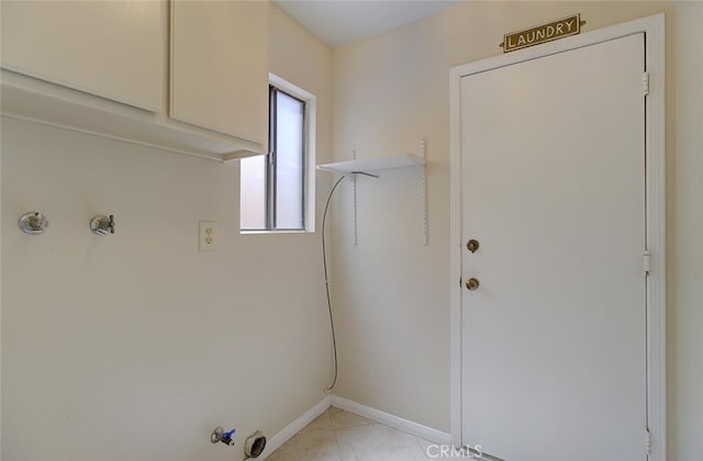 clothes washing area with gas dryer hookup and cabinets