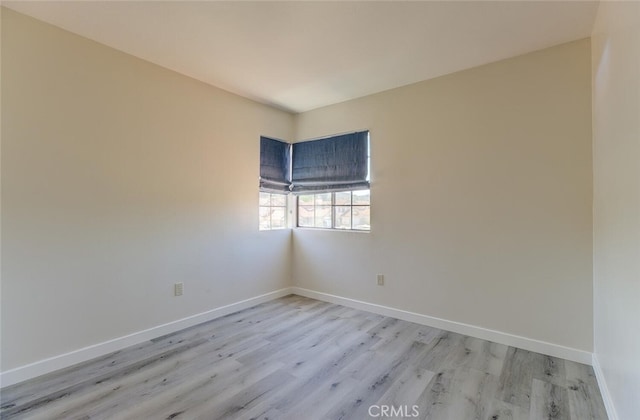 spare room featuring light hardwood / wood-style floors