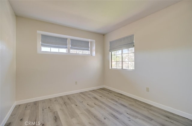 spare room featuring light hardwood / wood-style flooring