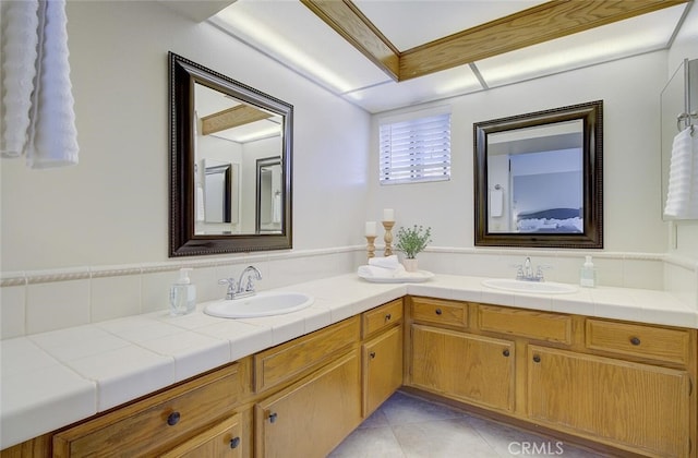 bathroom with tile patterned flooring and vanity