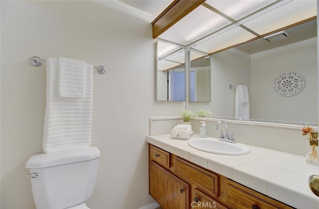 bathroom featuring toilet and vanity