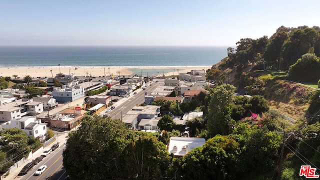 aerial view with a water view and a beach view