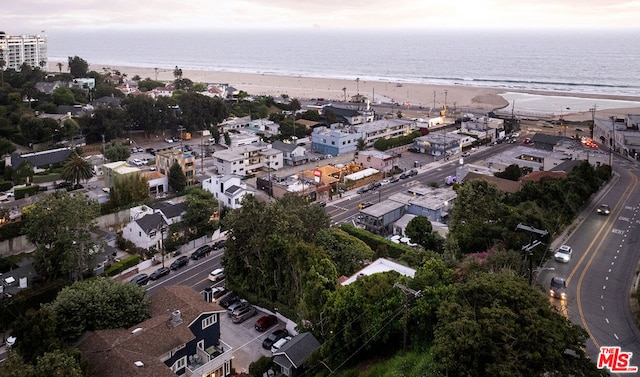 drone / aerial view featuring a water view and a view of the beach