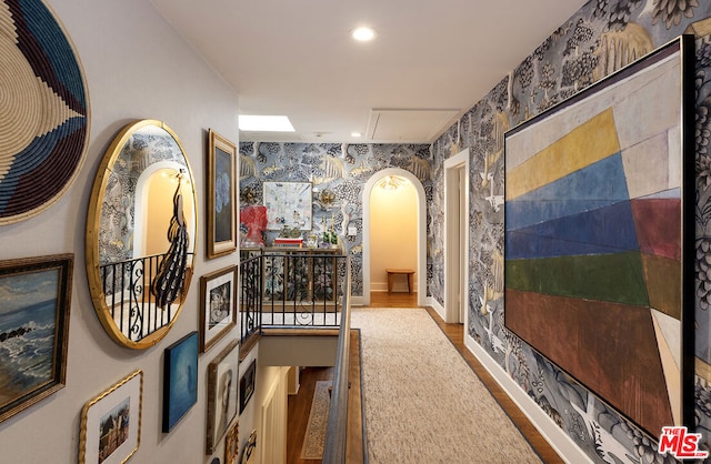 hallway with hardwood / wood-style floors