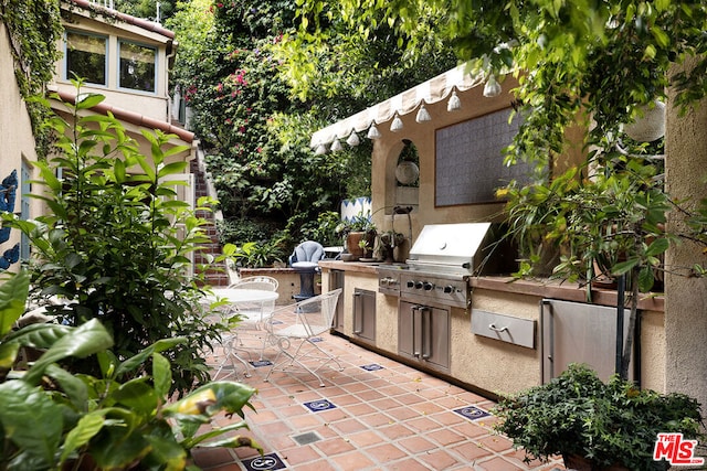 view of patio with an outdoor kitchen and area for grilling