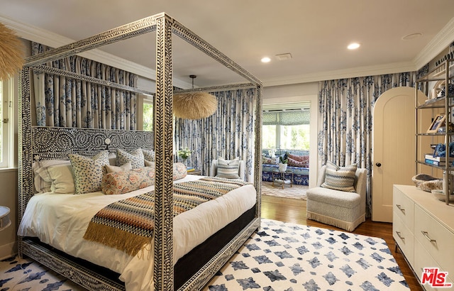 bedroom with ornamental molding and dark hardwood / wood-style floors