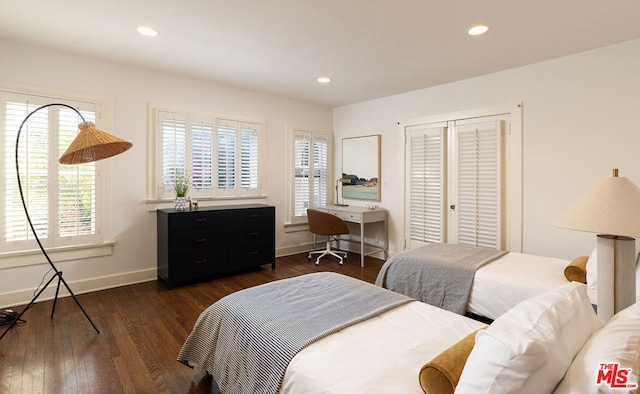 bedroom with dark hardwood / wood-style flooring