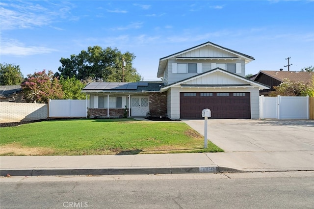 view of front of home featuring a front yard, a garage, and solar panels