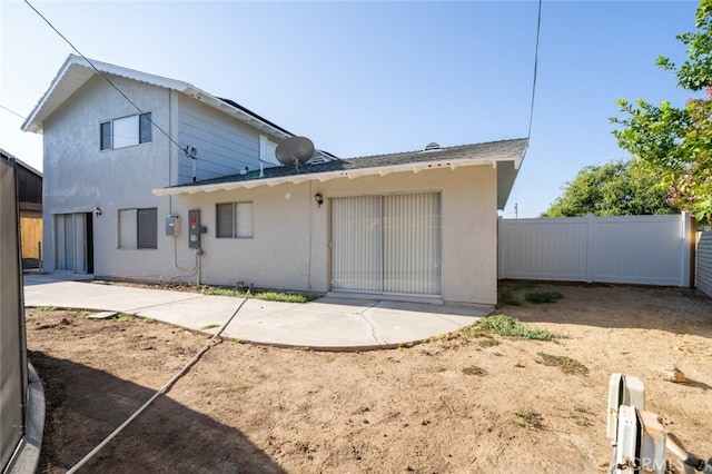 back of house with a patio