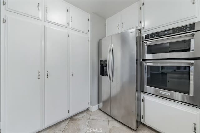 kitchen featuring white cabinetry, appliances with stainless steel finishes, and light tile patterned flooring