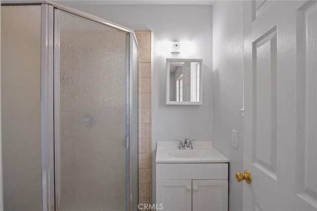 bathroom featuring vanity and an enclosed shower