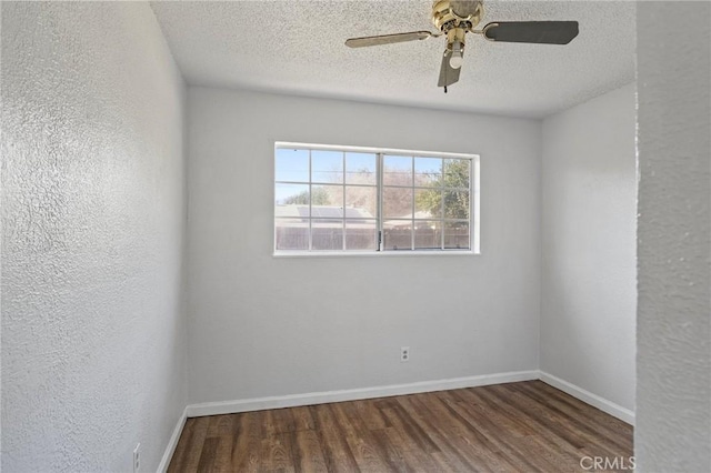 spare room featuring dark hardwood / wood-style flooring, ceiling fan, and a textured ceiling