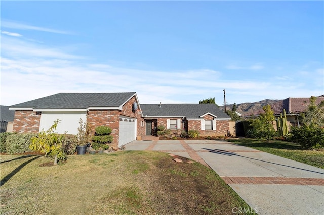 ranch-style house featuring a front lawn and a garage