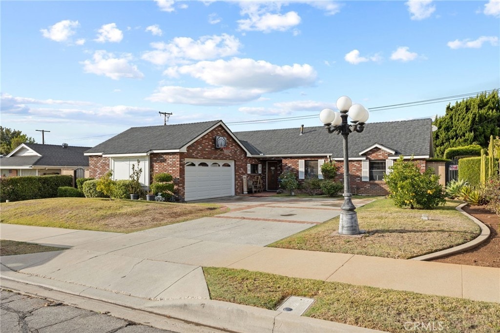 ranch-style home with a front yard and a garage