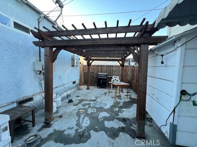 view of patio featuring area for grilling and a pergola