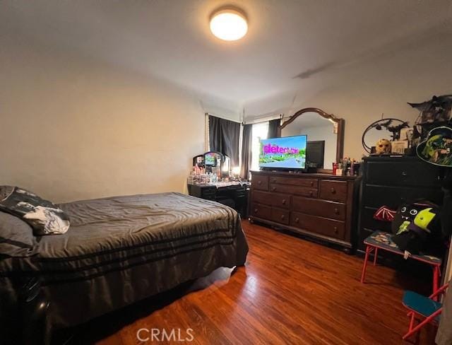 bedroom with hardwood / wood-style floors