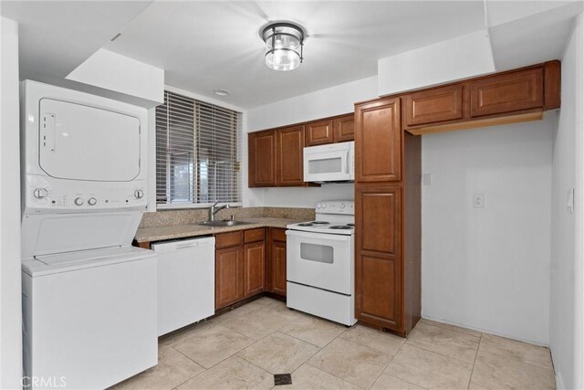 kitchen with sink, white appliances, and stacked washer / drying machine