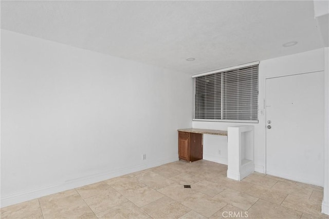 interior space featuring baseboards