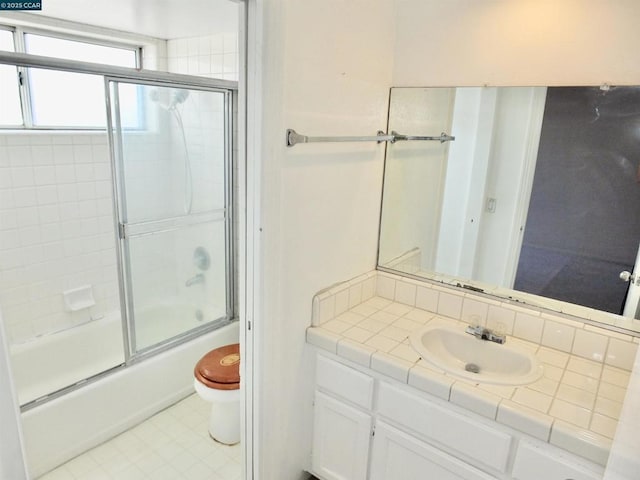 full bathroom with toilet, shower / bath combination with glass door, and vanity