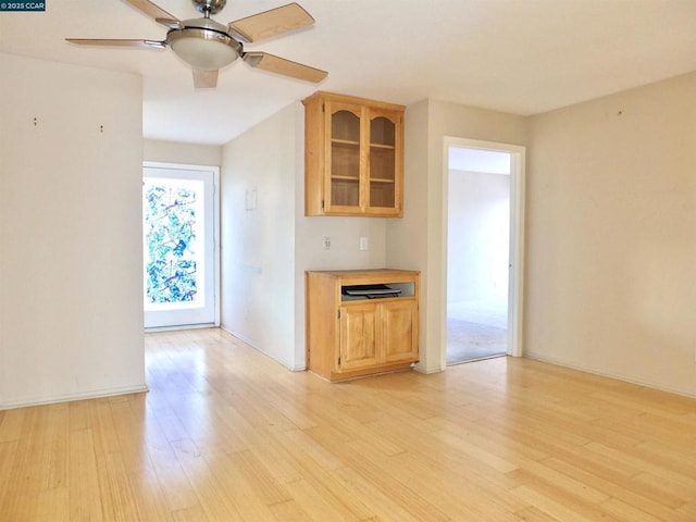 kitchen featuring light brown cabinetry, ceiling fan, and light hardwood / wood-style flooring