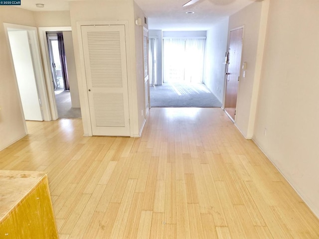 hallway with light hardwood / wood-style floors