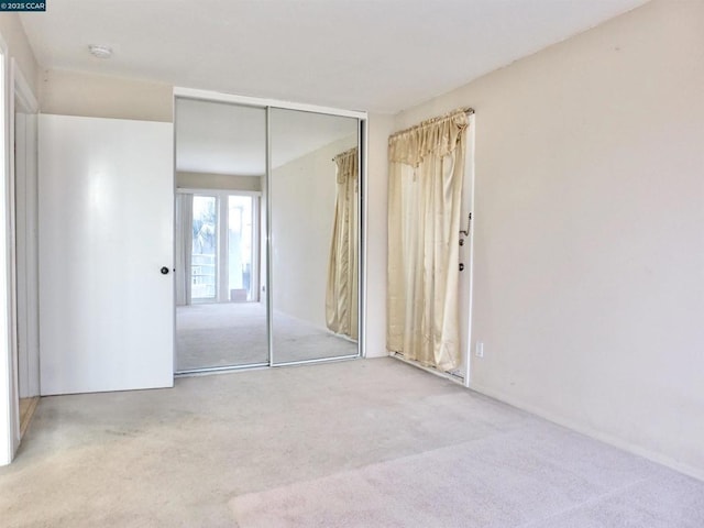 unfurnished bedroom with a closet and carpet flooring