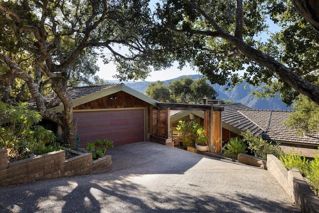 view of front of home featuring a garage and a mountain view