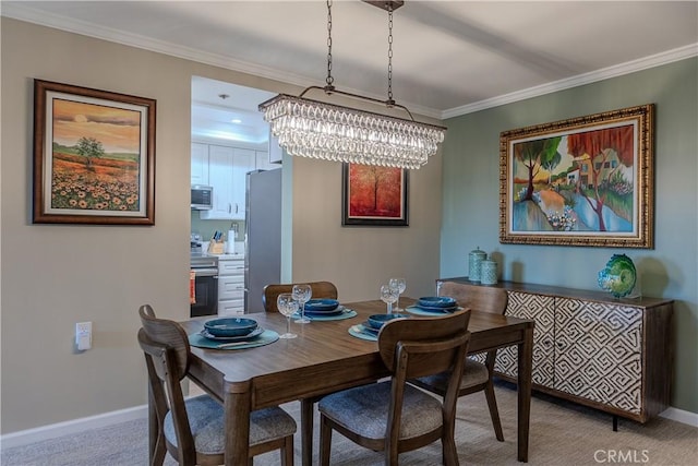 dining area featuring carpet flooring, crown molding, and a chandelier