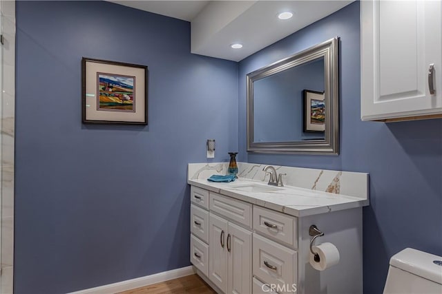 bathroom featuring vanity and toilet