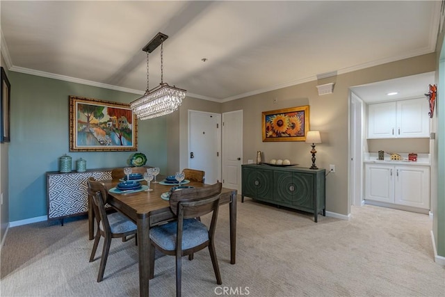 dining area featuring light colored carpet, crown molding, and a chandelier