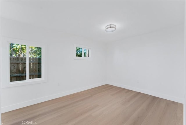 unfurnished room featuring light hardwood / wood-style floors and a wealth of natural light